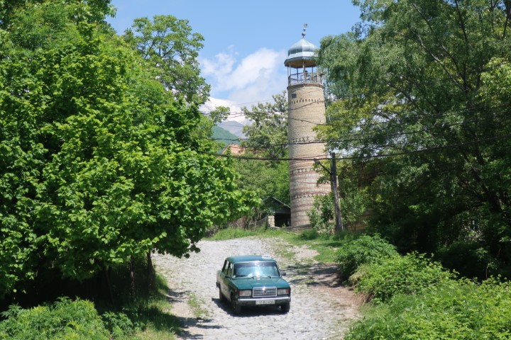 Lada driving past mosque in Kis village