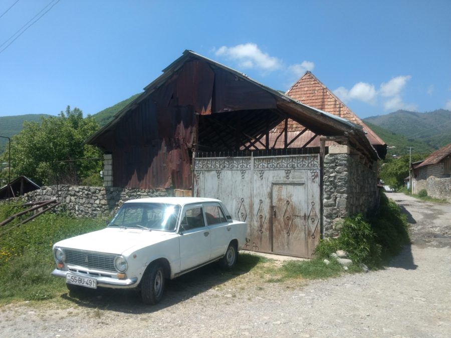Lada outside stone barn in Kis
